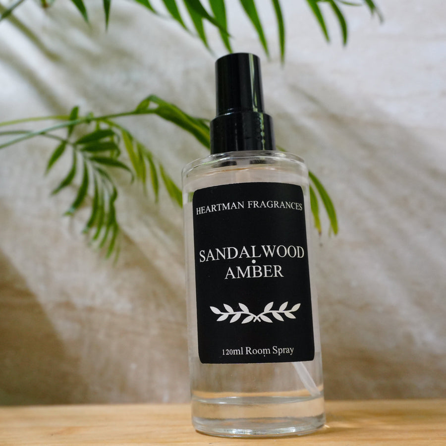 Sandalwood and Amber luxury room spray 120ml in a clear glass bottle by Heartman Fragrances