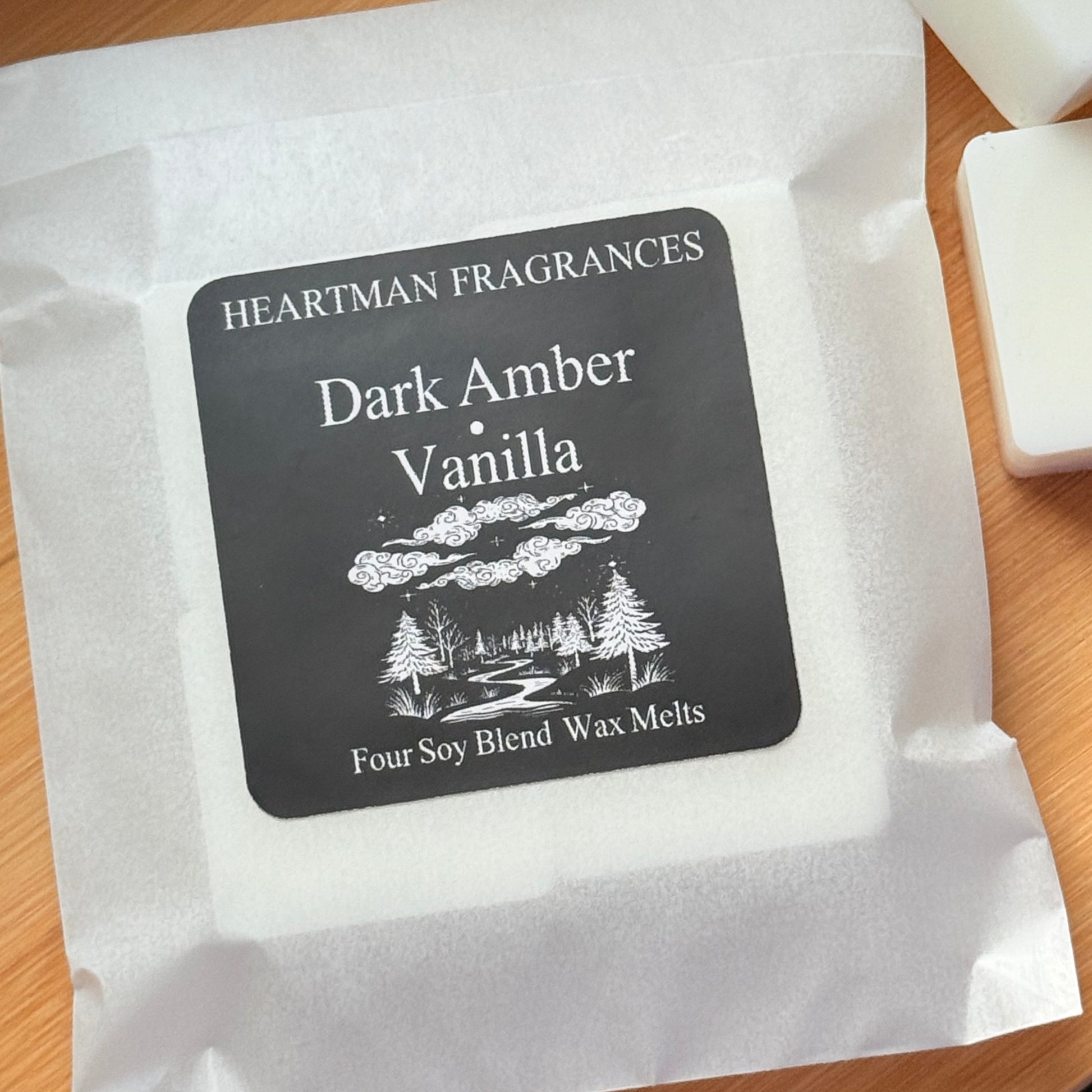 Wax melts packaging with 'Dark Amber Vanilla' label on a wooden surface